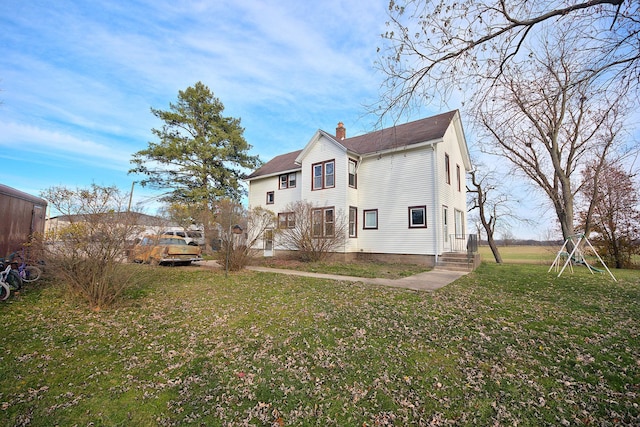 rear view of property with a lawn