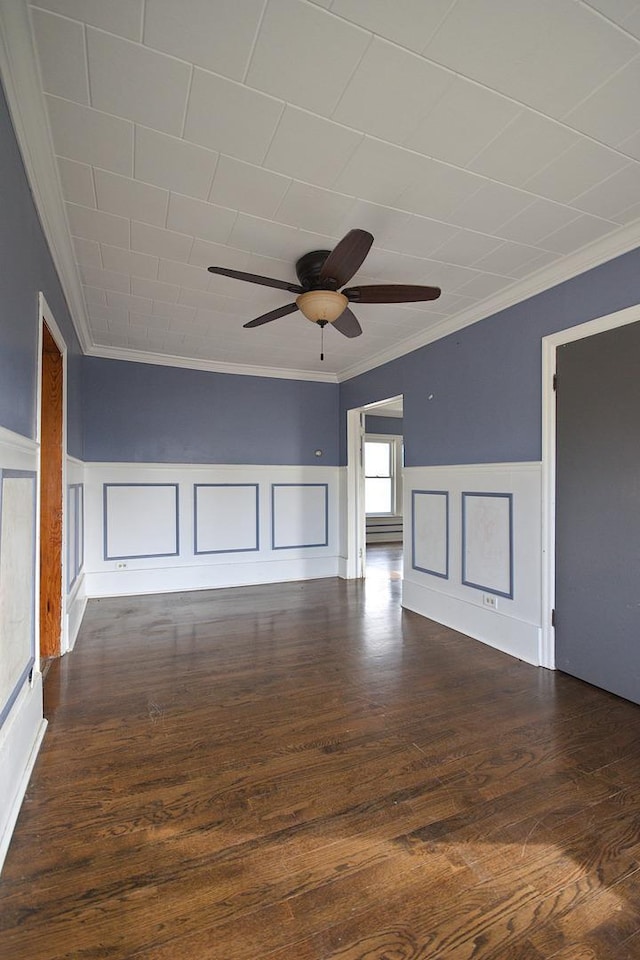 unfurnished room with ceiling fan, dark hardwood / wood-style flooring, and crown molding