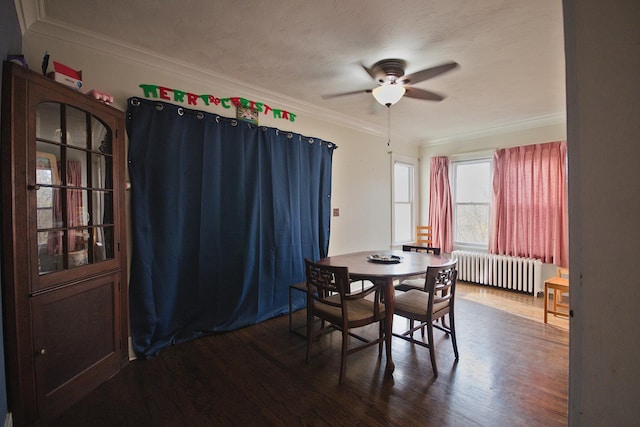 dining space featuring radiator, ceiling fan, hardwood / wood-style floors, a textured ceiling, and ornamental molding