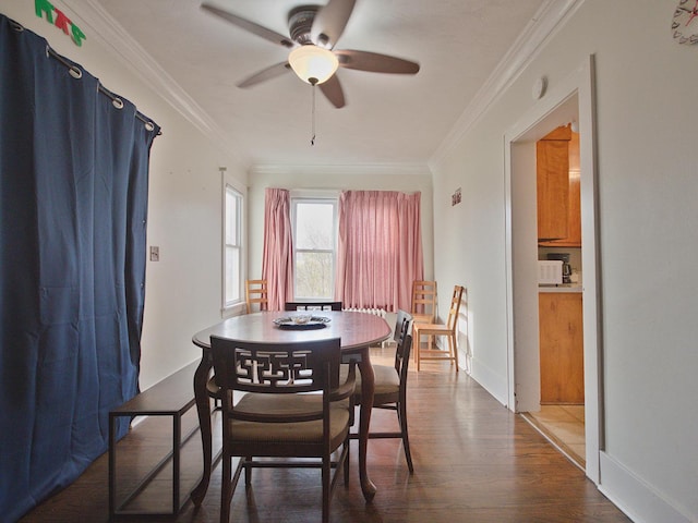 dining room with wood-type flooring, ceiling fan, and crown molding