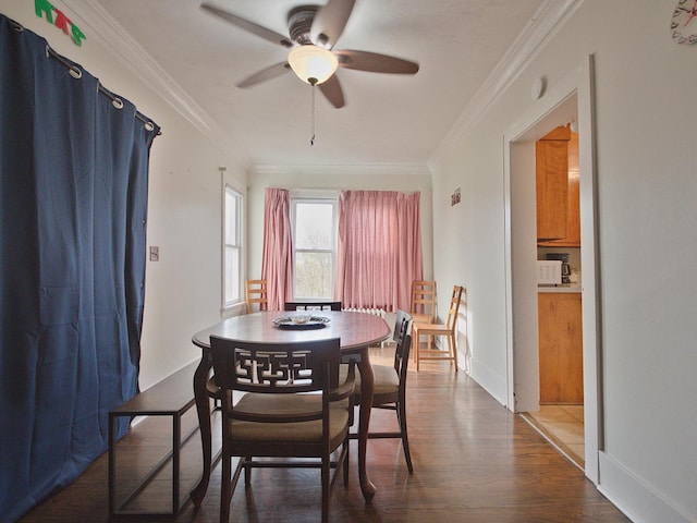 280A W Exchange St, Crete, IL 60417 - dining space featuring ceiling fan, crown molding, wood finished floors, and baseboards