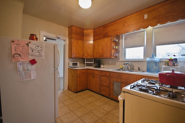 kitchen featuring white appliances and sink