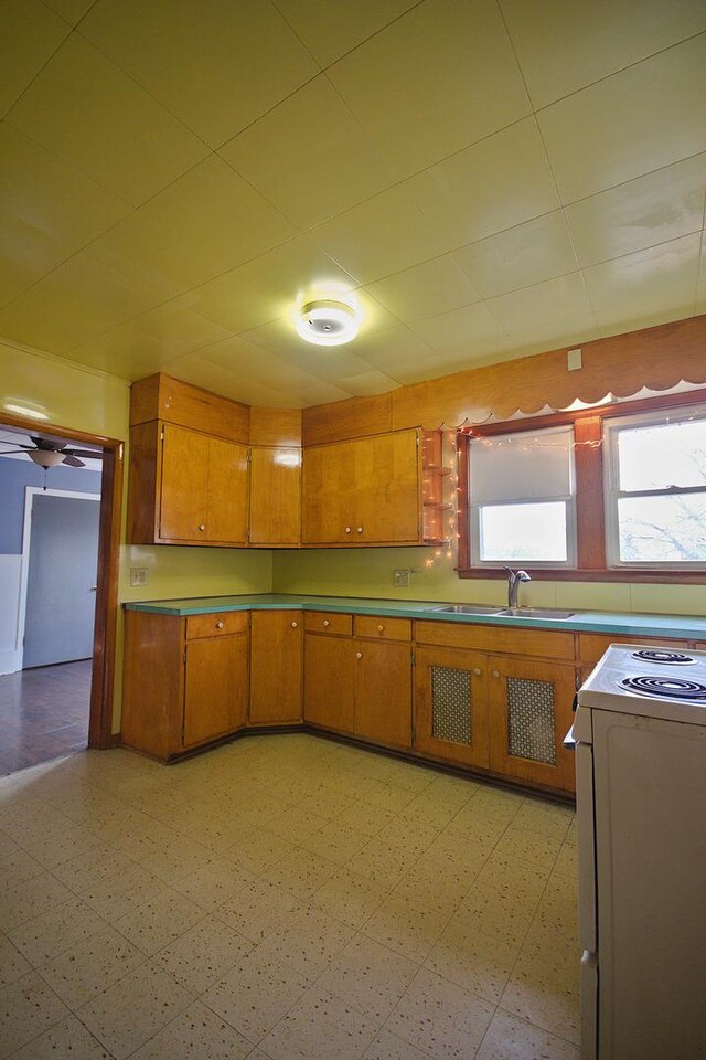 280A W Exchange St, Crete, IL 60417 - kitchen with a sink, light floors, brown cabinetry, and white range oven
