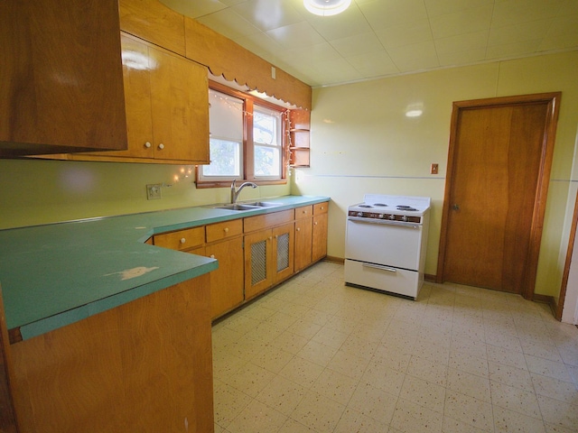 kitchen featuring sink and white stove