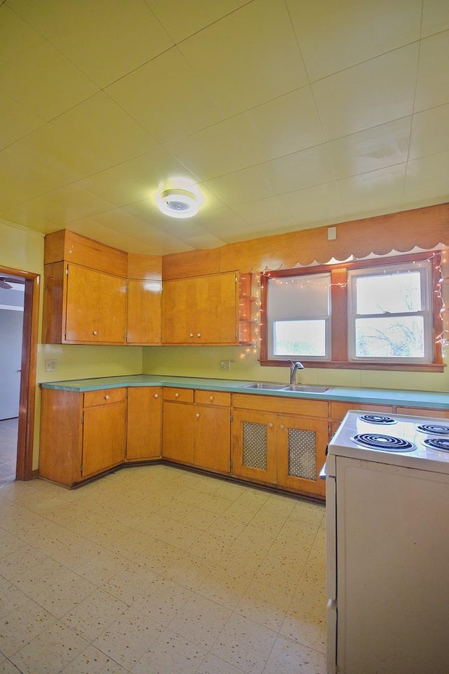 280A W Exchange St, Crete, IL 60417 - kitchen with a sink, white range with electric cooktop, light flooring, and brown cabinetry