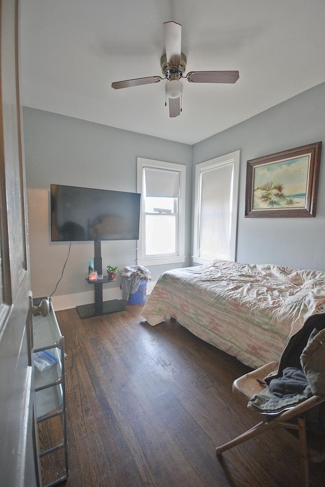 bedroom featuring ceiling fan and dark hardwood / wood-style floors