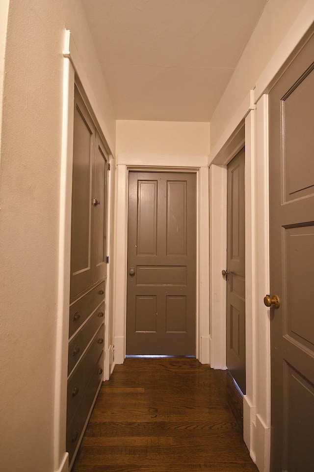 hall with dark wood-type flooring