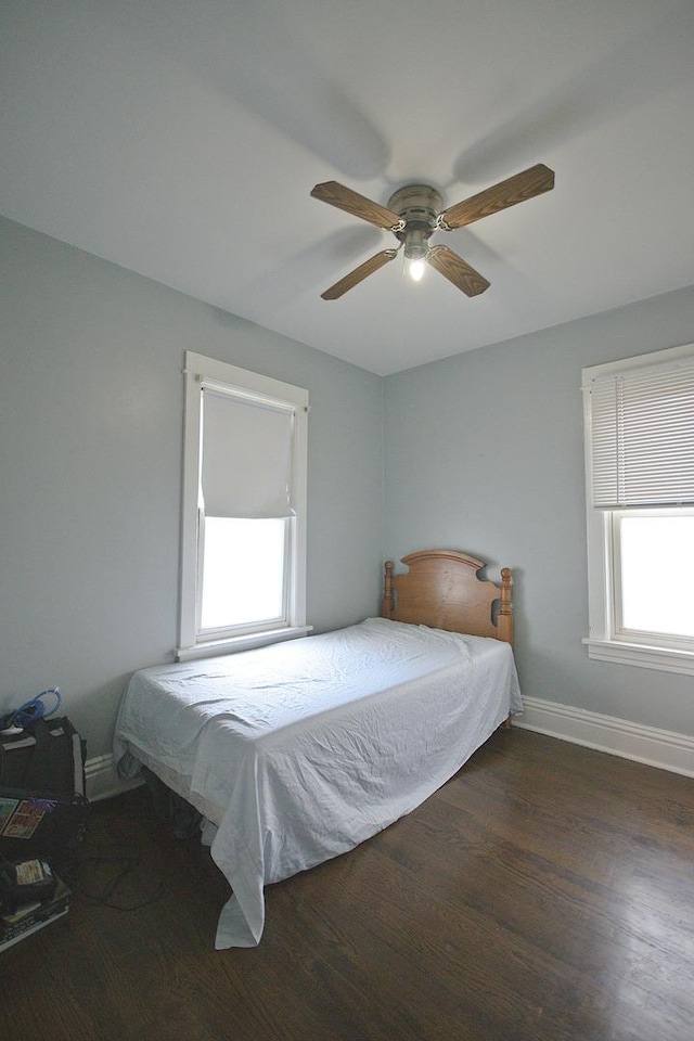 bedroom with dark hardwood / wood-style floors and ceiling fan