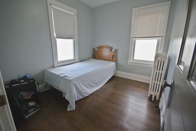 bedroom with dark wood-type flooring