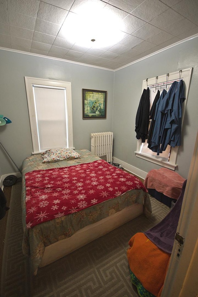 bedroom with carpet flooring, radiator heating unit, and ornamental molding