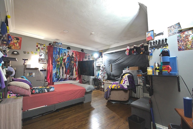 bedroom featuring hardwood / wood-style flooring and ornamental molding