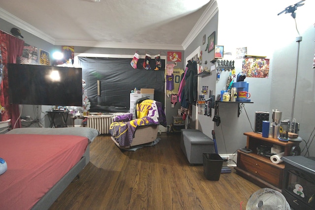 bedroom with hardwood / wood-style floors and ornamental molding