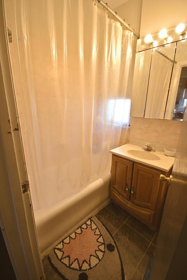 bathroom featuring backsplash, vanity, tile patterned flooring, and shower / bathtub combination with curtain