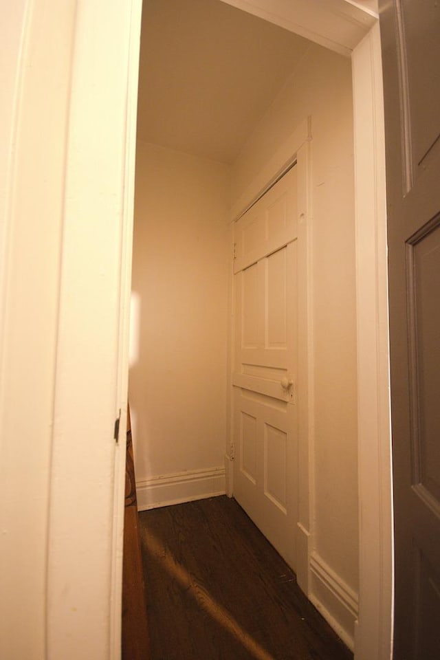 corridor with dark wood-type flooring