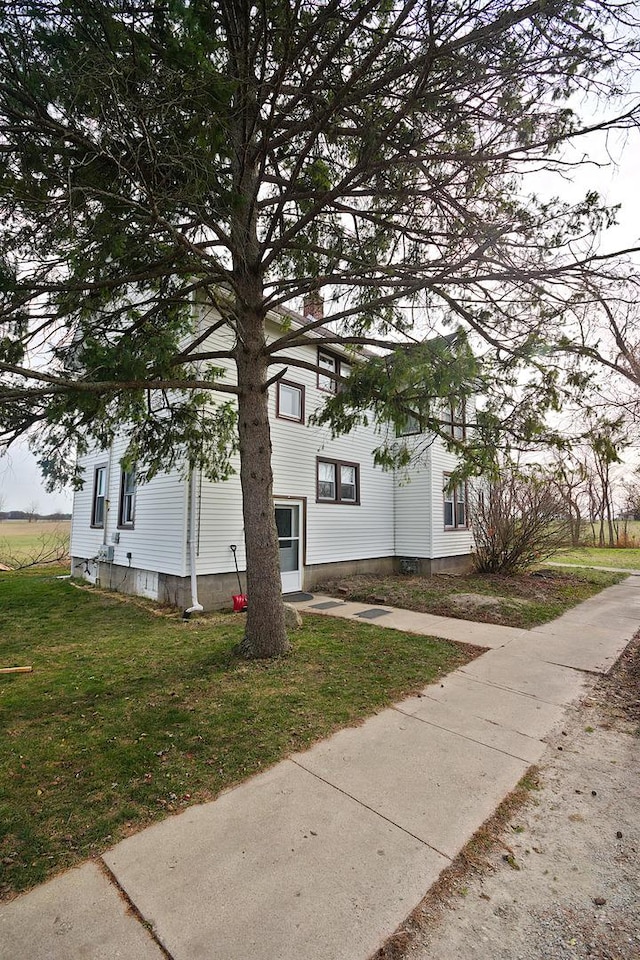 view of side of property with a lawn