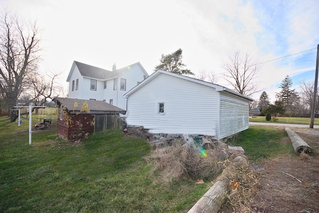 view of home's exterior featuring a sunroom and a yard