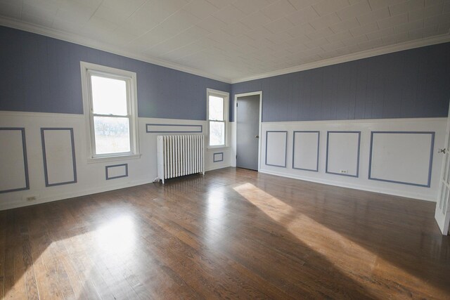 280A W Exchange St, Crete, IL 60417 - unfurnished living room with radiator, ornamental molding, wood finished floors, a decorative wall, and wainscoting