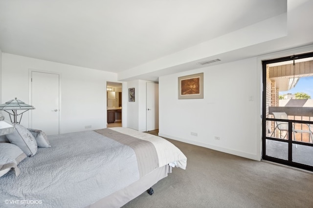 bedroom featuring connected bathroom, carpet, and access to exterior