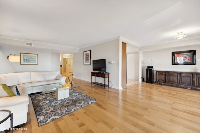 living room with ornamental molding and light wood-type flooring