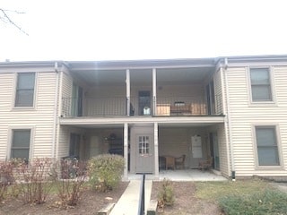 back of property featuring a balcony