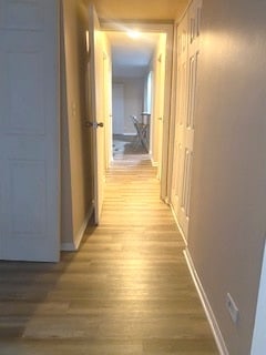 hall with hardwood / wood-style flooring