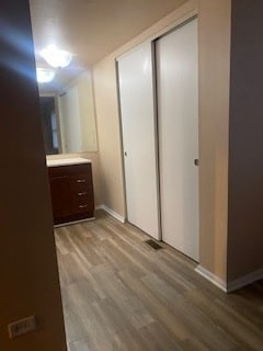 corridor with light hardwood / wood-style floors