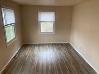 spare room with dark hardwood / wood-style floors