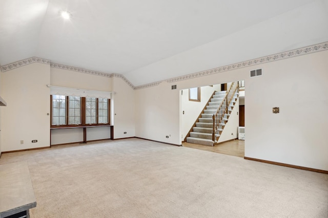 spare room with carpet flooring and lofted ceiling