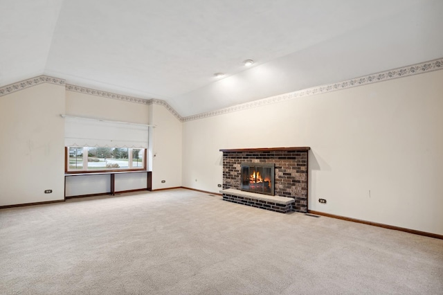 unfurnished living room featuring a fireplace, lofted ceiling, and carpet floors