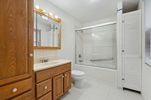 full bathroom with tile patterned floors, vanity, enclosed tub / shower combo, and toilet