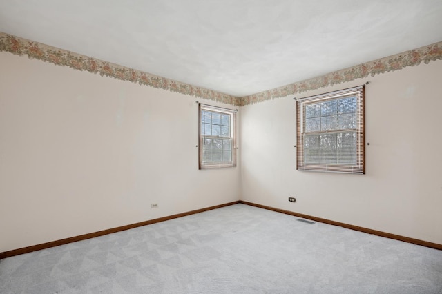 carpeted empty room with plenty of natural light