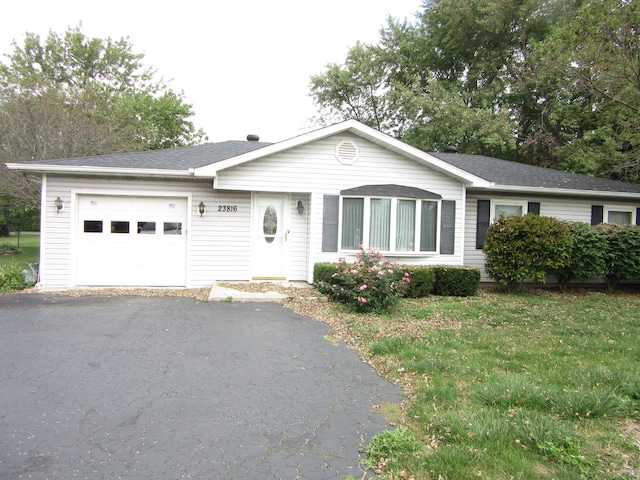 ranch-style house with a front yard and a garage