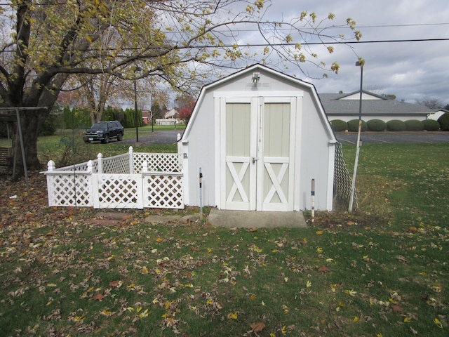 view of outdoor structure featuring a lawn