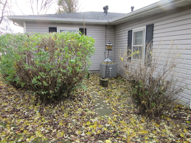 view of side of home featuring central AC