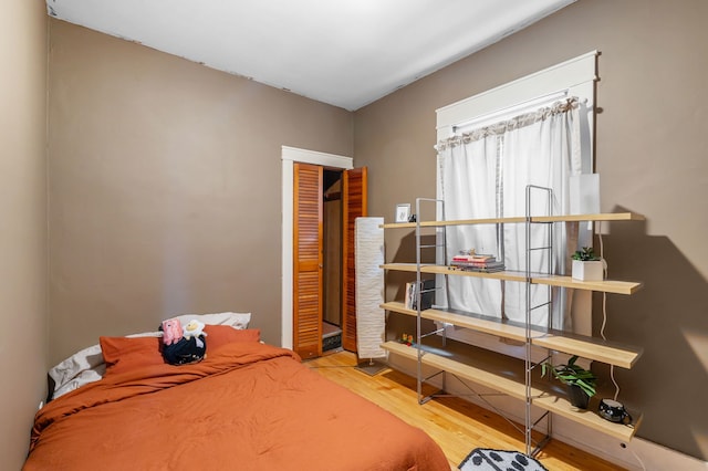 bedroom featuring wood-type flooring and a closet