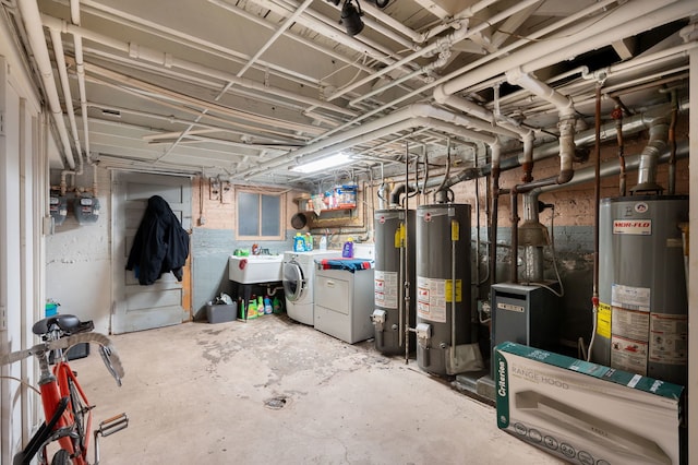 basement with gas water heater, washer and dryer, and sink