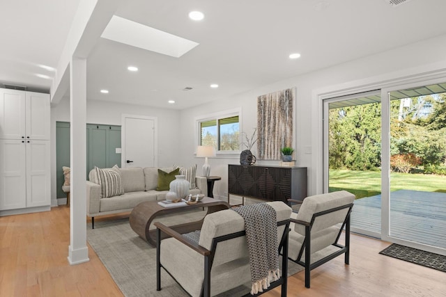 living room with plenty of natural light and light hardwood / wood-style flooring