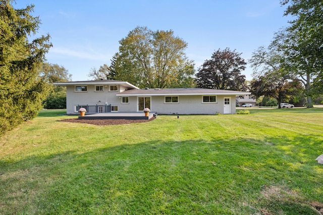 rear view of house with a lawn