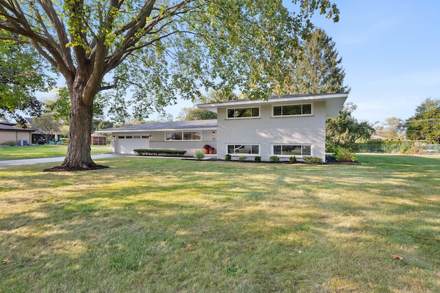 view of front of house with a garage and a front lawn