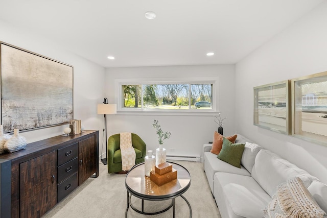 living room with light colored carpet and baseboard heating