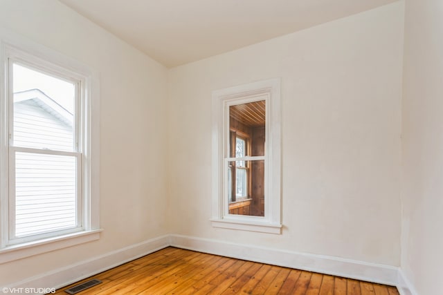 unfurnished room featuring light wood-type flooring and a wealth of natural light