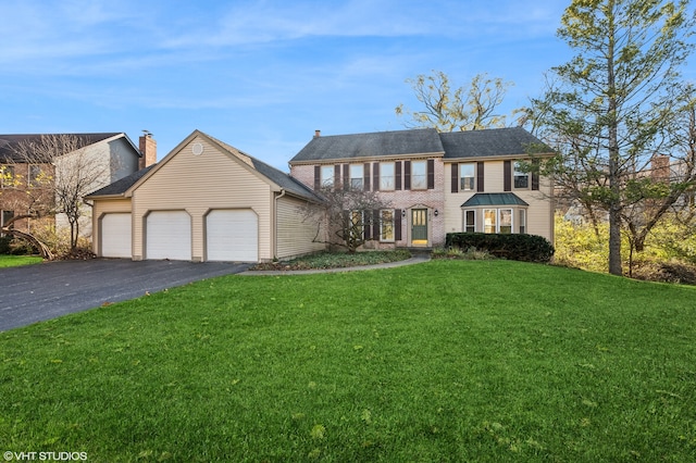 view of front facade featuring a front yard and a garage