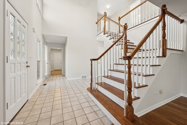 entrance foyer featuring light hardwood / wood-style floors and a high ceiling