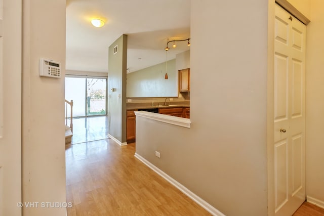 hall featuring sink and light hardwood / wood-style flooring