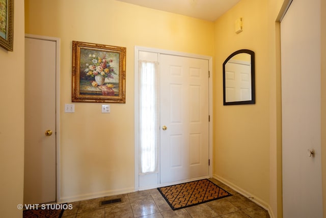 tiled entrance foyer with a wealth of natural light