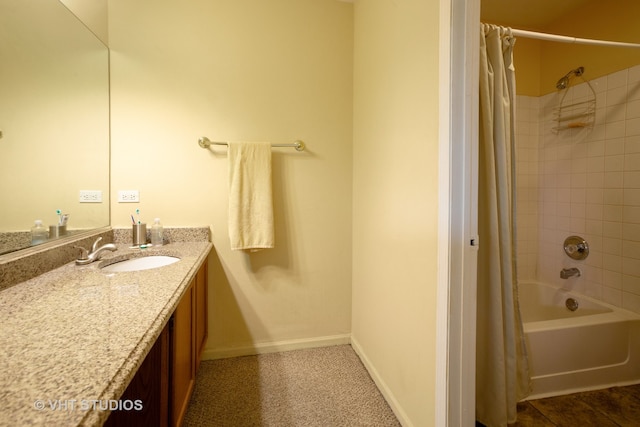 bathroom featuring shower / bath combo and vanity