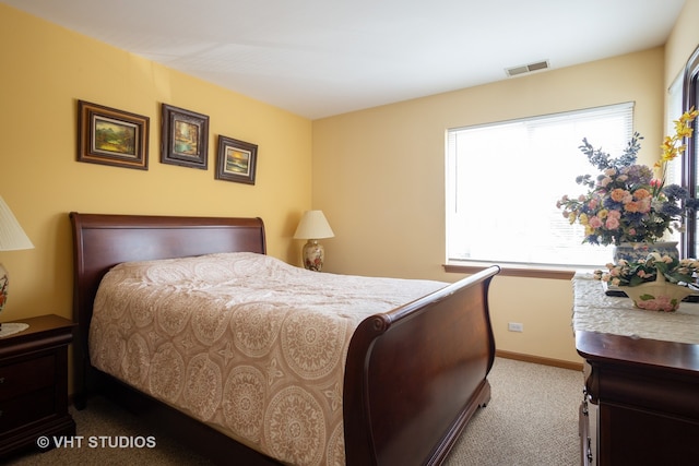 bedroom featuring light carpet