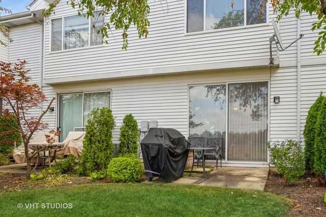 rear view of house with a yard and a patio