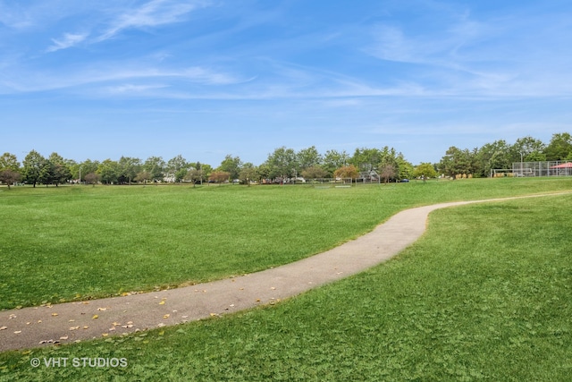 view of property's community featuring a yard and a rural view