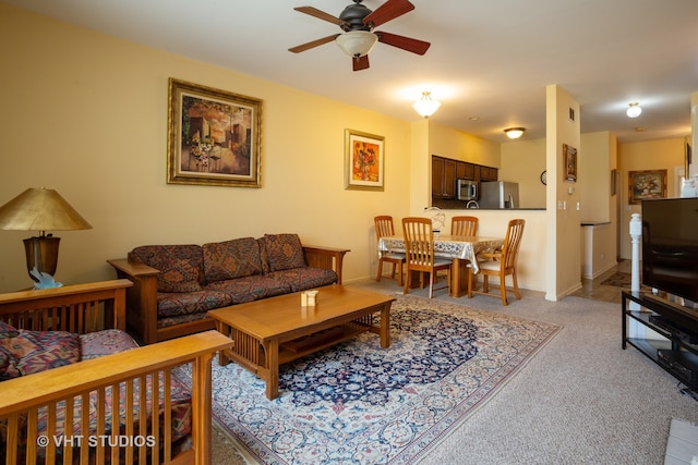 living room featuring ceiling fan and light colored carpet